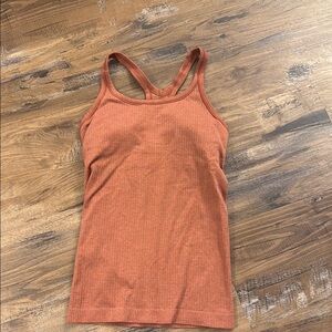 Lululemon woman’s size 4 “eb to street” rust/coral colored
Tank top